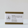 Soap in an olive green textured box with white belly band
