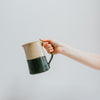 Hand Holding Dip Glaze Jug
