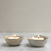 Two handmade pinch pots being used as tealight candle holders